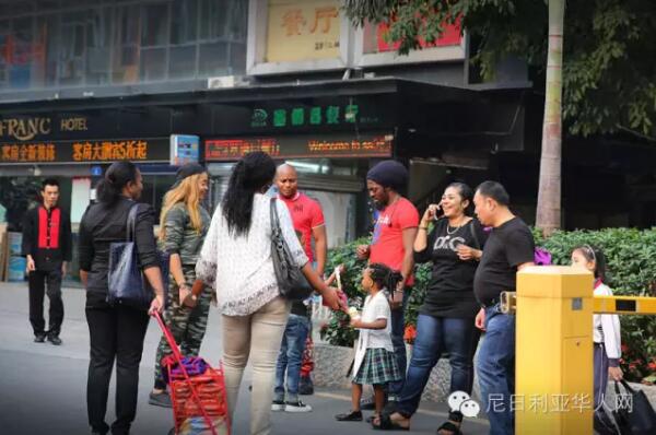 　　广州越秀区小北路靠近天秀大厦的天桥上人来人往，天桥下是车水马龙和远处耸立在灰霾中的高楼大厦。天桥的另一边，开往深圳的“和谐号”飞快地在铁轨上奔驰，发出巨大的噪音；铁轨下的桥洞里，小贩们正贩卖着各式的皮带、钱包、牛仔裤;理发的摊位上，剪刀“嚓嚓嚓”地响着。穿过桥洞，前面便是另外一个世界，一条只有短短几百米的街道。街道的名字叫宝汉直街，一处典型的城中村。图为穿过桥洞的非洲客往宝汉直街方向走来。  　　    　　街道的入口处是一座酒店改造成的的商贸城，车辆需保安放闸才能通过。再往里走，街道愈发狭窄，但凡有车经过，人群避让，灰尘扬起。  　　    　　据中国官方统计，2003年以后，在中非贸易热潮的带动下，赴广州的非洲人每年以30%至40%的速度递增。《广州日报》报道称，广州常住的外国人数已达5万，其中可统计的非洲人就有2万多。  　　    　　经常出没在广州或者曾经到过广州旅游的朋友们，肯定会经常看到一批一批的黑人在街上或者地铁公交上走动，非洲的部分黑人们来到中国找寻属于他们的“中国梦”的，就是这样一个小地方，这里可以见到来自80多个不同国家的人，其中大部分都是非洲商人。这条街，满足了他们几乎所有的生活所需。  　　    　　聚集在广州的黑人，很多由于签证过期的原因，无时无刻不处在被遣送回国的焦虑中，除了栖身之所和狭窄的店面外，他们哪里也不敢去。  　　    　　宝汉直街的非洲人主要来自于非洲的法语国家，例如刚果，几内亚，尼日尔，塞内加尔，他们大多数已经混出点名堂。可即便在这样的地方，拿着相机的人也会引来警惕的眼神，不但是黑人，甚至商铺里的中国人都会一直打量着你，直到你离开他所在的区域。  　　    　　对于远在中国的非洲人，他们的男女比例严重失衡，几乎都想找一个中国老婆，谁也无法说清这里爱的成分有多少，可一段跨国恋却一定能让他们安稳下来，不再惊慌和逃窜，可也并不是每个人都那么的幸运，能走到最后的也只是少数。  　　    　　对于中国人而言，都喜欢落叶归根，也时常能感受到那种身在异乡为异客的凄楚，但是对于非洲人而言，他们反而觉得来中国的生活其实过得很好，坦言很喜欢中国。  　　    　　据了解，目前一名普通非洲人来中国的费用，包括签证费1000元左右、来回机票费10000元左右、一个月时间在华食宿费用3000元左右，因此在来中国之前就至少要准备15000元以上才能确保成行。  　　    　　为什么选择来广州，而非其它城市?很多受访者认为是广州商品齐全物美价廉。  　　    　　一非洲女人自己在搬运货物。  　　    　　一非洲女人在水果店买水果。  　　    　　一位非洲女人在买衣服。  　　    　　一位非洲女人在内衣店试穿内衣，有两位中国女店员在帮忙试衣。  　　文章来自：东方网