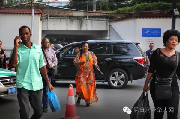 　　广州越秀区小北路靠近天秀大厦的天桥上人来人往，天桥下是车水马龙和远处耸立在灰霾中的高楼大厦。天桥的另一边，开往深圳的“和谐号”飞快地在铁轨上奔驰，发出巨大的噪音；铁轨下的桥洞里，小贩们正贩卖着各式的皮带、钱包、牛仔裤;理发的摊位上，剪刀“嚓嚓嚓”地响着。穿过桥洞，前面便是另外一个世界，一条只有短短几百米的街道。街道的名字叫宝汉直街，一处典型的城中村。图为穿过桥洞的非洲客往宝汉直街方向走来。  　　    　　街道的入口处是一座酒店改造成的的商贸城，车辆需保安放闸才能通过。再往里走，街道愈发狭窄，但凡有车经过，人群避让，灰尘扬起。  　　    　　据中国官方统计，2003年以后，在中非贸易热潮的带动下，赴广州的非洲人每年以30%至40%的速度递增。《广州日报》报道称，广州常住的外国人数已达5万，其中可统计的非洲人就有2万多。  　　    　　经常出没在广州或者曾经到过广州旅游的朋友们，肯定会经常看到一批一批的黑人在街上或者地铁公交上走动，非洲的部分黑人们来到中国找寻属于他们的“中国梦”的，就是这样一个小地方，这里可以见到来自80多个不同国家的人，其中大部分都是非洲商人。这条街，满足了他们几乎所有的生活所需。  　　    　　聚集在广州的黑人，很多由于签证过期的原因，无时无刻不处在被遣送回国的焦虑中，除了栖身之所和狭窄的店面外，他们哪里也不敢去。  　　    　　宝汉直街的非洲人主要来自于非洲的法语国家，例如刚果，几内亚，尼日尔，塞内加尔，他们大多数已经混出点名堂。可即便在这样的地方，拿着相机的人也会引来警惕的眼神，不但是黑人，甚至商铺里的中国人都会一直打量着你，直到你离开他所在的区域。  　　    　　对于远在中国的非洲人，他们的男女比例严重失衡，几乎都想找一个中国老婆，谁也无法说清这里爱的成分有多少，可一段跨国恋却一定能让他们安稳下来，不再惊慌和逃窜，可也并不是每个人都那么的幸运，能走到最后的也只是少数。  　　    　　对于中国人而言，都喜欢落叶归根，也时常能感受到那种身在异乡为异客的凄楚，但是对于非洲人而言，他们反而觉得来中国的生活其实过得很好，坦言很喜欢中国。  　　    　　据了解，目前一名普通非洲人来中国的费用，包括签证费1000元左右、来回机票费10000元左右、一个月时间在华食宿费用3000元左右，因此在来中国之前就至少要准备15000元以上才能确保成行。  　　    　　为什么选择来广州，而非其它城市?很多受访者认为是广州商品齐全物美价廉。  　　    　　一非洲女人自己在搬运货物。  　　    　　一非洲女人在水果店买水果。  　　    　　一位非洲女人在买衣服。  　　    　　一位非洲女人在内衣店试穿内衣，有两位中国女店员在帮忙试衣。  　　文章来自：东方网