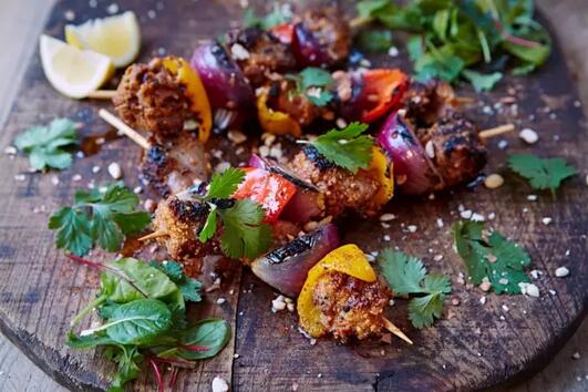 　　吴京、卢靖姗、张翰主演的《战狼2》上映两周票房已近40亿元，堪称下半年杀出来的一匹大黑马，刷屏微博朋友圈。而随着电影的热映，非洲再次热起来!今天就给大家推荐非洲十大国民美食，看看有没有办法跟咱们的美食比?  　　1、肯尼亚——食肉苑烤肉  　　    　　说起肯尼亚，大家想到的除了马拉松运动员，估计就是各种各样的野生动物了，什么狮子、猎豹、鳄鱼之类的。对于大多数旅行者来说，来肯尼亚的目的就是为了看看这些动物。其实，这些动物除了可以看，还是可以吃的哦……  　　在肯尼亚，最出名的餐厅非“食肉苑”莫属。在食肉苑，你想到的想不到的肉类，都会出现在你的饭桌上。鳄鱼、斑马、鸵鸟等，这些在食肉苑成为了香喷喷的烤肉。当然，这些都是经过政府特许的，其中不少是养殖的动物，吃起来不要有太大的心理压力哦~  　　    　　食肉苑的烤肉是不放香料的，只在烤制的时候放一点点盐即可。吃的，就是肉的本味。当然，你要是觉得太重口了，也有牛肉、羊肉、鸡肉之类的，每种都有着让你惊喜的口味。再来上一杯肯尼亚最受欢迎的Tusker啤酒，配着由土豆泥、青豆、玉米、南瓜叶做成的营养配菜，完美!  　　    　　2、加纳——Chichinga  　　    　　想吃最地道的加纳美食，就别去那些五星级酒店啦，因为那都是面向游客的。想吃最地道的美食，最好的去处当然还是街头啦。俗话说的好，美食在民间嘛。  　　来到加纳的街头，你会发现很多地方都在卖烤肉。这种烤肉名叫Chichinga，是加纳目前最流行的美食之一。Chichiga有牛肉、鸡肉或者香肠三种，有的中间会搭配上一些蔬菜。烤好之后，可以选择刷花生酱或者是香料。总的来说，黑哥们用料还是相当大方的，一口下去全是满足感。  　　    　　3、安哥拉——姆安巴鸡  　　    　　在安哥拉人的餐桌上，最常见的几样食材是木薯、花生、玉米和辣椒、鸡肉。因为靠海的缘故，海鲜也是他们的常客。但是，最值得推荐的还是一道名为姆安巴鸡的菜。  　　这道菜算是安哥拉的国菜，有人将其称为安哥拉美食的珍宝，属于来安哥拉必吃的美食!姆安巴鸡用棕榈油配上大蒜、辣椒、黄秋葵炒制而成，口味辛辣，又带有独特的香料味，和咖喱鸡块看起来有点像，口味也有几分相似，算是中国人比较能接受的菜之一。  　　    　　4、莫桑比克——霹雳霹雳鸡  　　    　　在大多数人的印象中，莫桑比克就是个天蓝海清的度假胜地，大家白天潜水、钓鱼，晚上吃海鲜烧烤喝酒的国家。但实际上，这里除了海鲜，还有不少好吃的东西。  　　莫桑比克最经典的菜并不是各类海鲜大餐，而是一道名为“piri piri chicken”，翻译过来大概就是「霹雳霹雳鸡」。这道菜，继承了非洲饮食一贯的风格：卖相欠佳，口味倒是不错，如果鸡肉不烤的太老那就完美了。  　　霹雳霹雳鸡在上架烤之前，要先用青柠汁、大蒜、椰奶、辣酱油、辣椒腌制，之后上烤炉上烤，烤到表皮微焦即可。吃的时候搭配炸薯条，或者裹上花生酱和椰奶，拌着木薯叶子吃，都是不错的吃法。  　　    　　5、赞比亚——恩希玛  　　    　　大部分在非洲的朋友，其实对这道菜不会陌生。在不同的国家，它有着不同的名字：在肯尼亚和坦桑尼亚，它叫乌伽利;在南非，它叫PAP;在乌干达，它叫波绍。而在赞比亚，它的名字叫恩希玛(nshima)。  　　不管名字叫啥，它的用料都是差不多的，主要材料就是玉米粉。这道菜的做法倒是有点意思：将玉米粉放在碗里，添水，用勺子来回划，中间不断添加玉米粉，直到行成粘稠的糊状物。据吃过的华人表示，感觉就是团毫无味道的糯米团子……  　　    　　在小编看来，恩希玛倒是有点像中国人吃的饭或者馒头，属于主食一类的，吃的时候必须要配上两个小菜。菜的种类就很多样了：各类炖牛羊鸡肉，蔬菜的话有南瓜叶、秋葵之类的。喜欢的话，可以淋上各种酱汁，中国人的老干妈我觉得就是个不错的选择~  　　    　　6、埃及——Koshari  　　    　　埃及有三宝：水烟、香水、Koshari。来埃及旅行，什么金字塔、狮身人面像之类的是肯定要看的，Koshari则是肯定要吃的。毕竟，它好歹是埃及的国菜来着……  　　Koshari在埃及属于国民美食，不管是去当地朋友家中，还是在街头闲逛，都能看到这道菜的身影。Koshari的主要材料为大米、通心粉和小扁豆，在烹调的时候，不同的菜料要分开来煮，最后再拌到一起。做好之后，上面可以再配上香脆的炸洋葱，淋上辣番茄酱，风味颇为独特。  　　    　　总的来说，Koshari还是比较能够满足国人的胃口的，虽然卖相不一定有那么好，不过还是值得一试的美食~  　　    　　7、尼日利亚——Jollof rice + Egusi soup  　　    　　尼日利亚是非洲人口最多的国家，这里旅游资源不多，但经济还不错，算得上全非前几名，因而在尼日利亚工作的华人不少。尼日利亚有一系列的传统美食，不过最值得一试的还要属Jollof rice + Egusi soup的组合。  　　Jollof rice主要的食材有大米、西红柿、各种肉类、洋葱和胡椒。这道菜的做法有点类似于西班牙海鲜饭：先用黄油将各种肉类、蔬菜炒一下，再将大米放进去炒上两分钟，最后加上肉汤煮半个小时左右，差不多汤汁都收进去了，就可以出锅了。  　　    　　Egusi soup，这玩意儿名字里虽然带“soup(汤)”，但给小编的感觉更像东北乱炖：将瓜子、蔬菜、鱼干、肉等一堆乱七八糟的东西用棕榈油炒一遍，之后加水炖熟即可，里面的汤汁并不是很多。通常情况下，Egusi soup是配着乌伽利一起吃的，不过按照中国人的饮食习惯，配上面的饭吃也是个不错的选择。  　　不过还是要吐槽一句：这道汤的外形实在太糟糕了好吗!看了完全没食欲……  　　    　　8、埃塞俄比亚——英吉拉  　　    　　作为埃塞俄比亚的国民美食，英吉拉属于埃塞人每天必吃的食物。但是中国人却难以接受英吉拉的味道。这种食物用一种名为苔麸的奇特谷物制成，做出来有点像薄煎饼，不过表面上更加粗糙，看起来有点像……牛肚。  　　中国人之所不喜欢吃英吉拉，最主要的还是接受不了它的味道。英吉拉是一种发酵食物，因而吃起来会有股独特的酸味，不少人形容它有点像是食物放馊了的味道。不知怎的，小编总是会想起北京的豆汁，感觉两者味道有些相似之处……  　　    　　一盘最经典的英吉拉，配料应该是包含上面几种的，包括肉、蔬菜和酱汁，也算得上是营养全面了。只要你能习惯这种口味，那么就可以在埃塞街头尽情享受这种美食~  　　    　　9、桑给巴尔岛——biryanis  　　    　　说起桑给巴尔岛的美食，怕是很多人第一反应就是这里的龙虾大餐。不过嘛，龙虾再好，也不可能天天吃，算不上国民美食。这里的人，吃的最多的还是一道饭：biryanis。  　　biryanis，中国人一般称它为印度鸡肉香饭。不要奇怪，因为桑给巴尔岛就在印度洋的西岸，印度人来这儿已经有几百年历史了，因而印度的饮食文化对当地的影响着实不小，这道菜就是个典型的例子。  　　    　　做biryanis，要选用米粒较长的印度香米。煮的时候，要先用香料之类的腌好鸡肉，再将米饭煮到半熟，加入腌好的鸡肉入烤箱烤制。煮出来的饭色泽金黄，香米自带的坚果香味和香料味会混合在一起，闻起来香气扑鼻，带有浓郁的印度风情。  　　    　　10、南非——神肉比尔通  　　    　　神肉比尔通，听起来就好像来头很大的样子。当年，这个肉曾经是某位中央大人物非常喜欢的零食，不少中国人就是因为他而知道了比尔通。至于这位大人物是谁嘛，嘿嘿，大家还是自己百度吧~  　　之所以叫神肉，是因为做这种肉的材料很奇特。做神肉比尔通，最常见的肉是牛肉。除了牛肉之外，也是最容易购买到的。鳄鱼肉、羚羊肉、鸵鸟肉都可以做为材料，最珍贵的据说就是羚羊肉制成的比尔通。  　　    　　比尔通表面上看起来黑乎乎的，切开来之后，却是外黑里红，香软爽口。制作这种肉的时候，要将生肉放入果醋和香料中进行长时间的浸泡，然后放在太阳下晒干。吃这种肉的时候，最好的方式就是生吃，口感最好，入口后既能感觉到牛肉的新鲜味道，又能感受到香料带来的独特辛香。如果觉得生肉不放心的话，也可以蒸熟食用。  　　    　　上面这些食物究竟好吃与否，不同人估计会有不同的看法，觉得特别好吃的人应该不多，毕竟咱中华美食也算是世界顶级水平嘛!不知小伙伴们怎么看?  　　文章来自：食尚亚洲